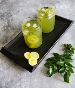 Curry leaves lemonade | Curry leaves cooler served in glasses on a black tray