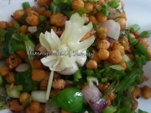 Kabuli Chana Salt Pepper served on a white platter with spring onion