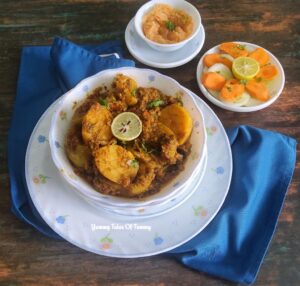 Bharwa Tinda | Stuffed Apple Gourd served in a white bowl with salad and chutney on the side