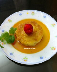 Leftover Bread Pudding served with cherry on the top, caramel sauce and a ming sprig