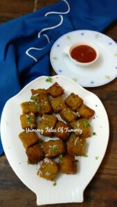 Kothimbir Vadi | Corn kothimbir vadi served on white platter 