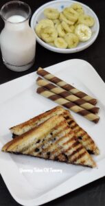 Chocolate fruit sandwich served with bananas and milk