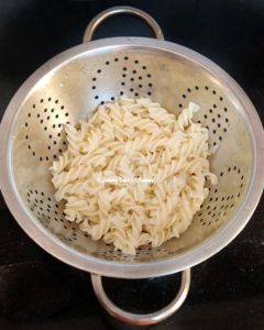 Boiled pasta in colander