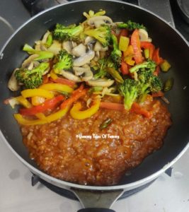 Sauted vegetables with red sauce in a pan