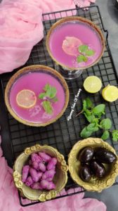 Aerial view of jamun panna served in glasses with lemon and mint 