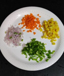 Chopped vegetables kept on white plate to make Sooji paniyaram recipe | Instant Rava Appe Recipe 
