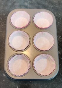 Muffin pan lined with paper liners