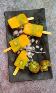 Overhead view of 3 ingredient Fresh Fruit Popsicles on a black serving tray