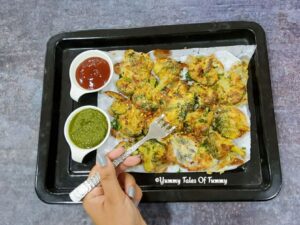 Aerial shot of Air fryer Malai Broccoli Tikka | Broccoli in Air fryer served with green chutney and tomato sauce 