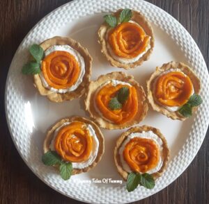 Eggless Mango mini tarts | Mango tarts served in a white plate
