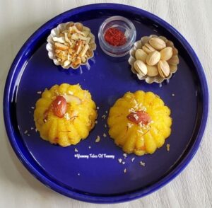 Rava Kesari Recipe | Kesari Bath served in a blue plate with pistachios and saffron on side