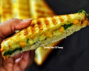 Spinach Corn Sandwich Recipe | Palak sweetcorn sandwich slice in hand 