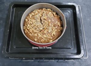 Baked eggless whole wheat date walnut cake placed on tray