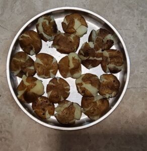 Boiled potatoes pressed between palms 