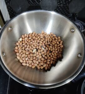 Dry roasted peanuts in a steel kadai