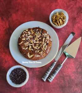 Eggless Whole wheat Banana Cake (vegan) ready to serve alongside Choco chips and walnuts 