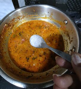 Adding sugar to the sabzi to balance the flavors 