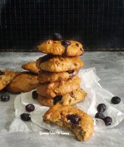 Vegan Banana Blueberry cookies stacked on a parchment paper