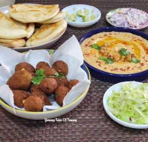 Vegan Falafel Recipe | Falafel Recipe platter consisting hummus, Falafel, Pita bread and some salad on the side