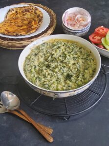 Methi Matar Malai Recipe served with paratha, onions and salad on the side