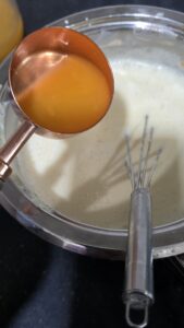 Mixing orange juice to the cream