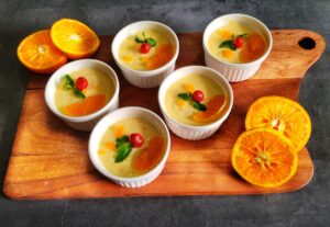 Orange Posset Recipe (No bake) served in remakins with mint leaf and cherry.