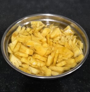 Chopped pineapple immersed in salted water 