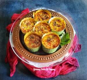 Eggless Pizza Muffins Recipe (yeast free) served on a black platter 