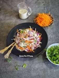Easy Coleslaw Recipe (Vegan) served alongside dressing and shredded carrots 