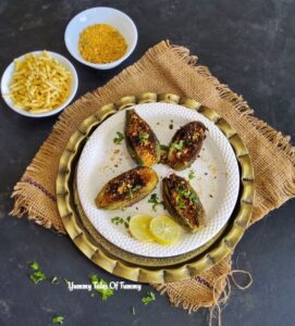 Besan Bharwa Karela | Stuffed Bitter Gourd served on white plate 