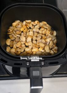 Butter beans in a bowl with seasoning and oil ready to be Air fried