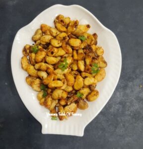 Air Fryer Crispy Butter Beans served with coriander leaves on a white platter