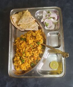 20 - minute Anda Bhurji | Egg bhurji | Masala Scrambled eggs served in a steel plate with chapatis and sliced onions on the side